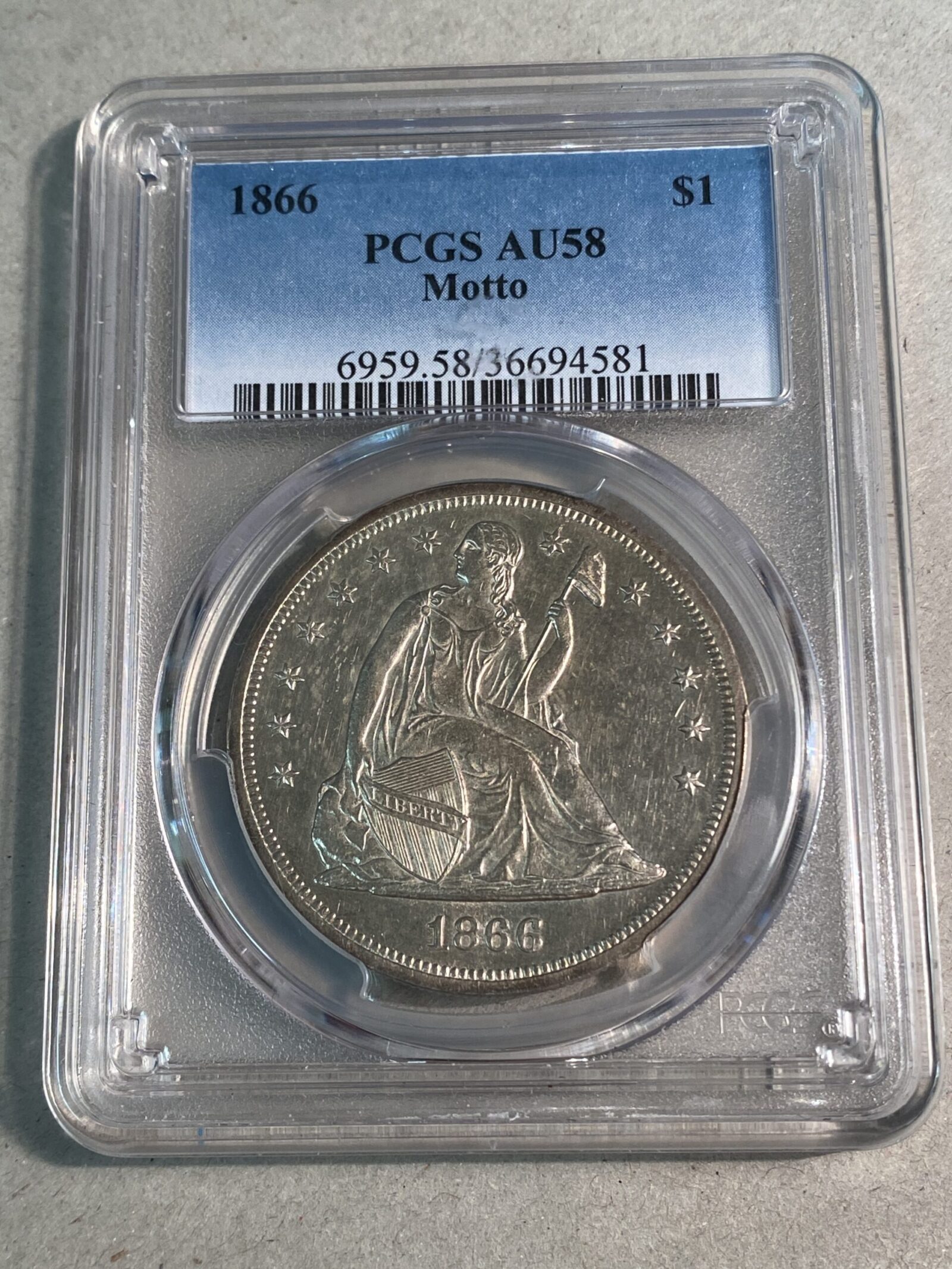 1866 Seated Liberty Silver Dollar, Motto, PCGS AU58
