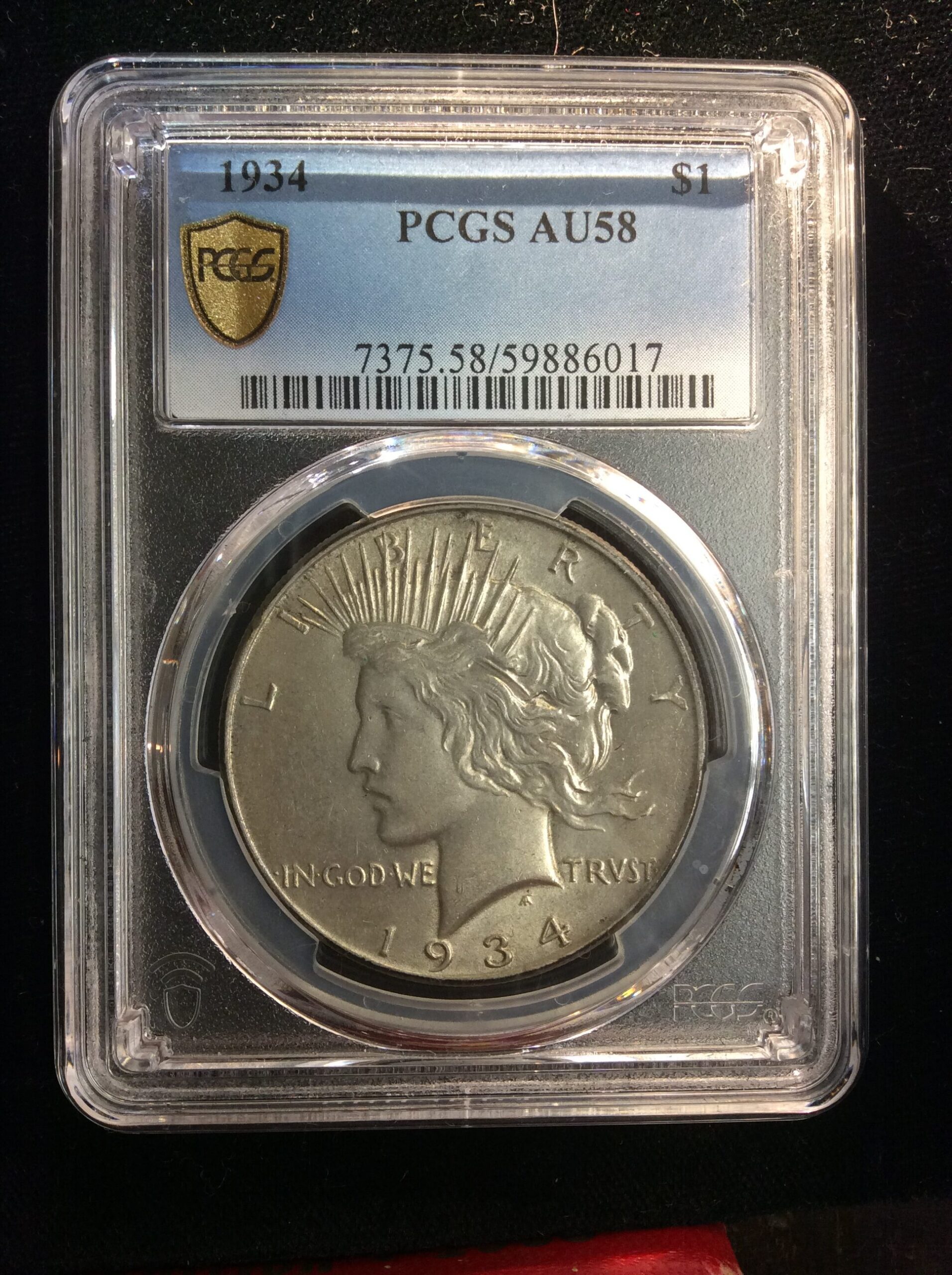 1934 Peace Dollar in a PCGS AU 58 Holder