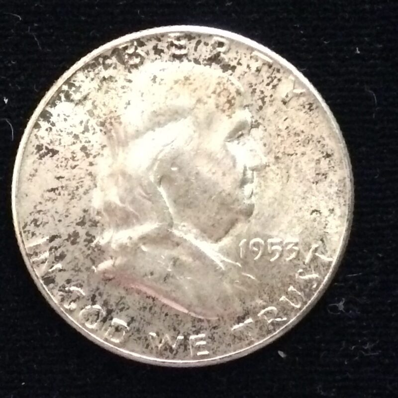 1953 Franklin Half Dollar in MS63 with some dark toning.
