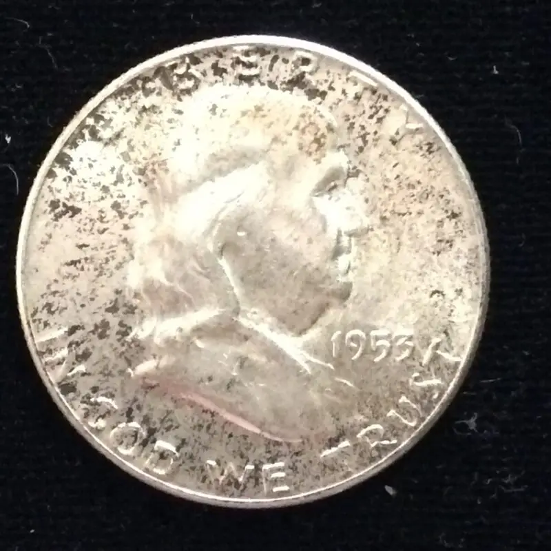 1953 Franklin Half Dollar in MS63 with some dark toning.